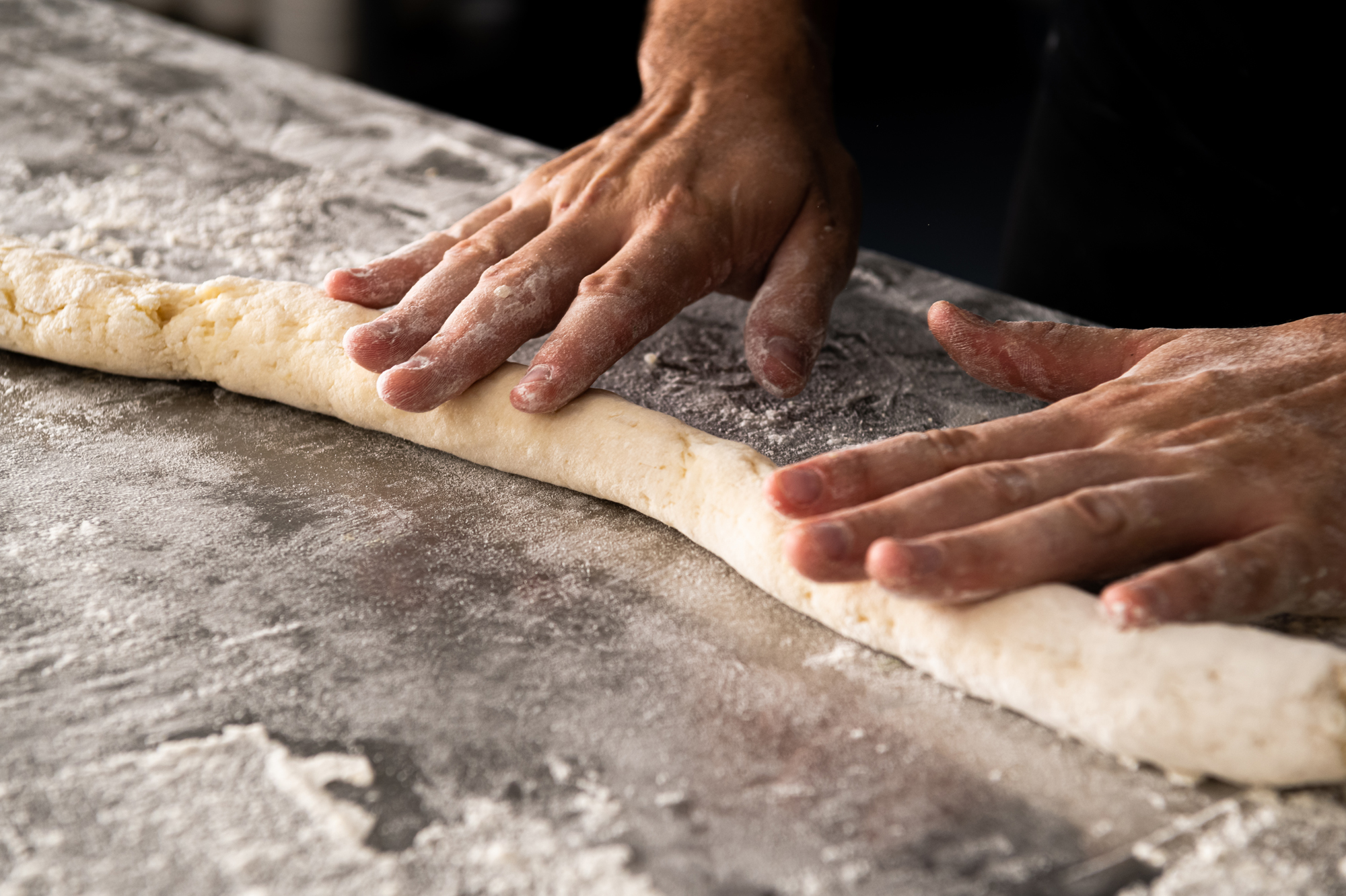 Chef rolling pasta dough at Water St Kitchen